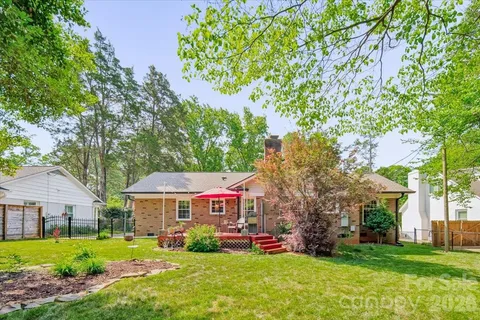 a view of a house with a yard and sitting area