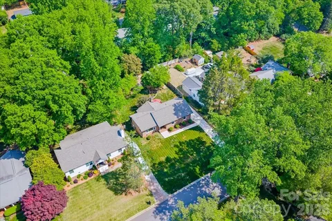an aerial view of house with yard and swimming pool