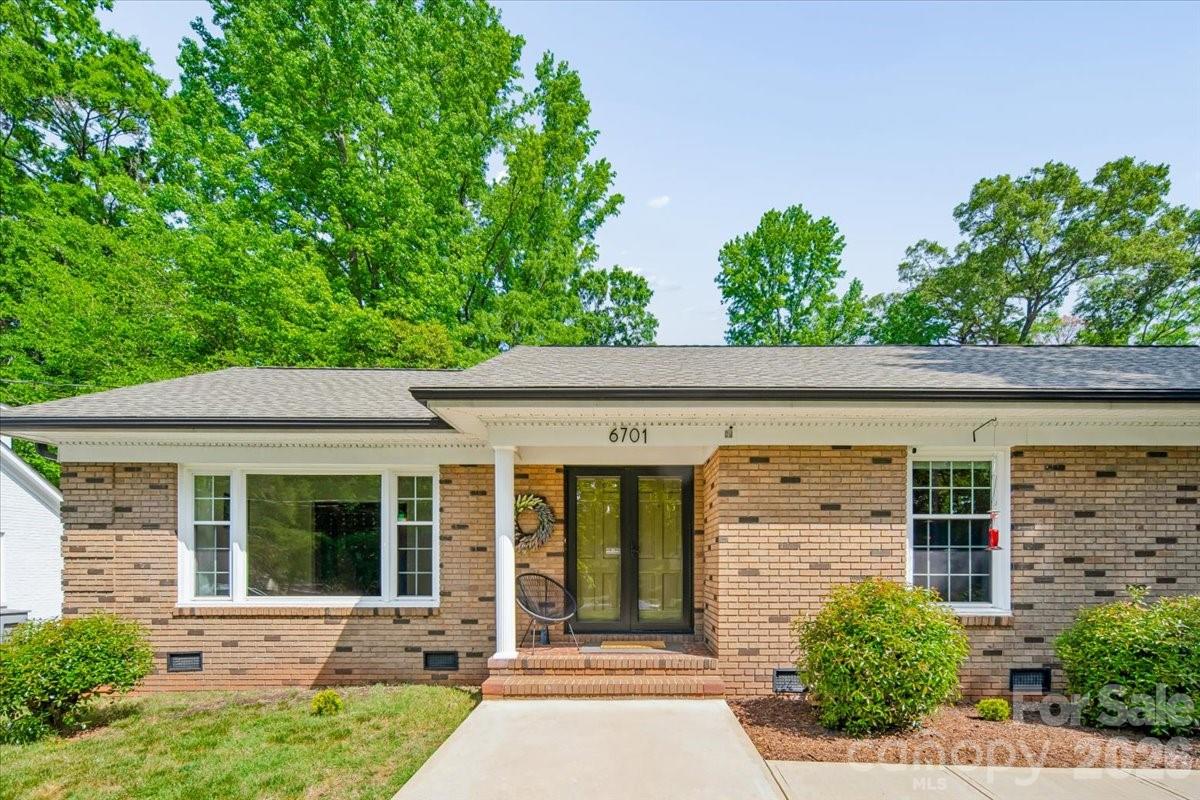 6701 Ronda Avenue Charlotte, NC 28211 - Photo 6 of 46 front view of a house with a large window and potted plants