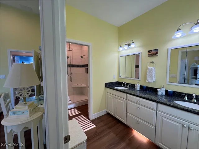 a bathroom with a double vanity sink and a mirror