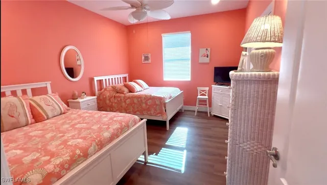 a bedroom with two beds and a chandelier