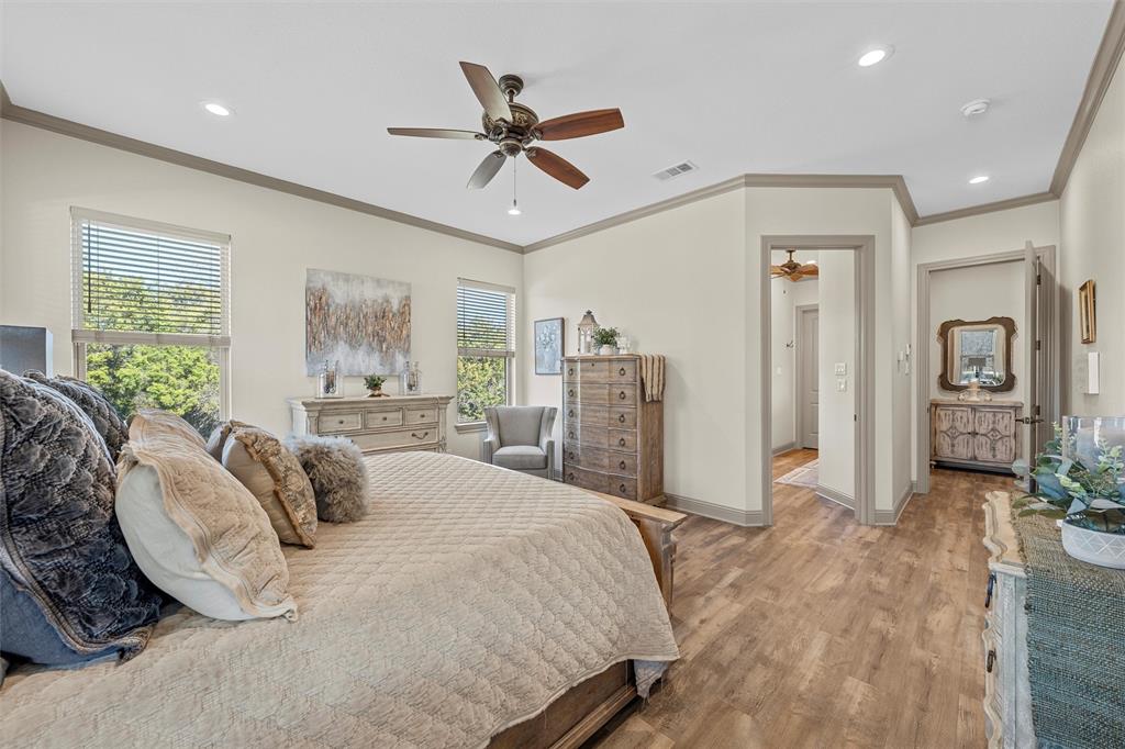 18503 Wortham Bend Road China Spring, TX 76633 - Photo 21 of 40 a bedroom with a bed and glass walk in closet
