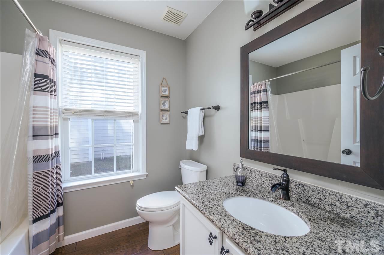 4520 Drewbridge Way Raleigh, NC 27604 - Photo 18 of 22 a bathroom with a granite countertop sink a toilet and a mirror