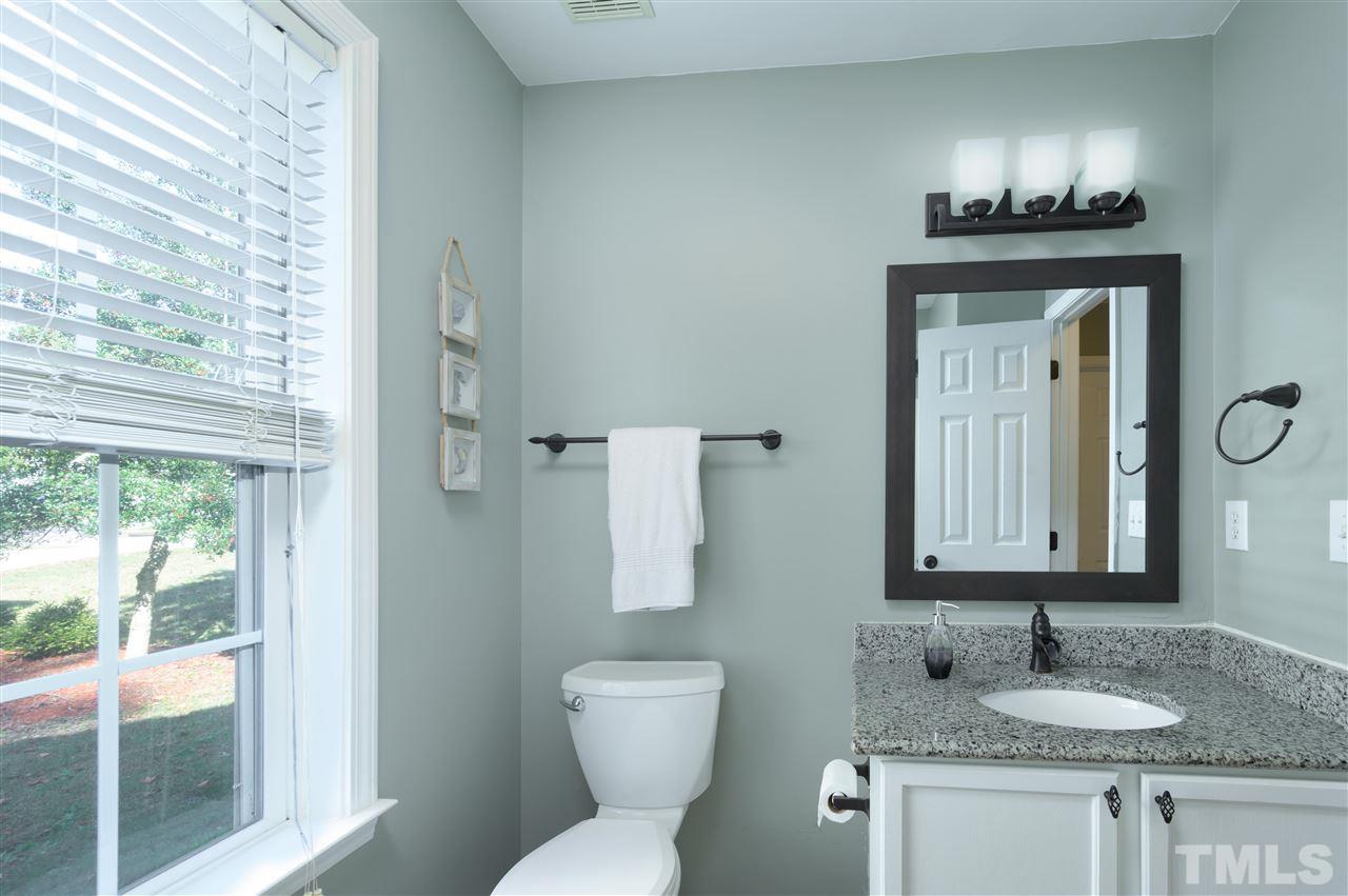 4520 Drewbridge Way Raleigh, NC 27604 - Photo 19 of 22 a bathroom with a granite countertop sink vanity and a mirror