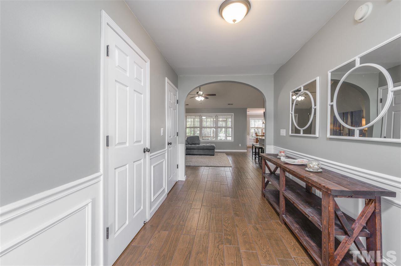 4520 Drewbridge Way Raleigh, NC 27604 - Photo 5 of 22 a view of a hallway to a livingroom with furniture