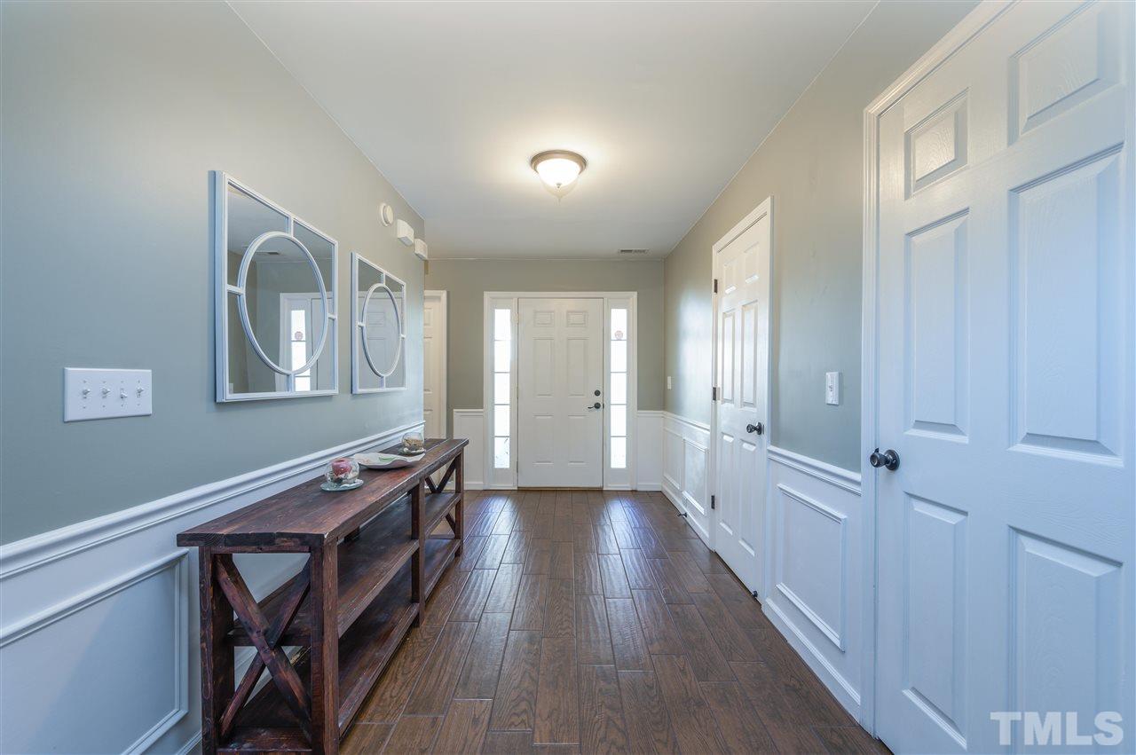 4520 Drewbridge Way Raleigh, NC 27604 - Photo 6 of 22 a hallway with wooden floor closet and windows