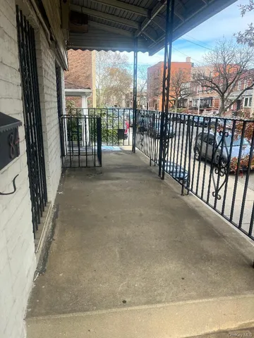a view of a porch with a floor to ceiling window