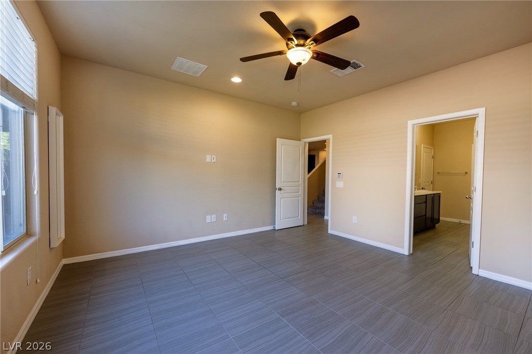 11016 Prairie Grove Road Las Vegas, NV 89179 - Photo 14 of 37 A generously sized room with tile flooring and an overhead fan awaits your personal touch.
