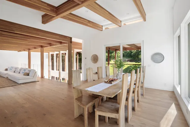 a view of a dining room with furniture and a large window