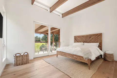 a bedroom with a bed and a large window