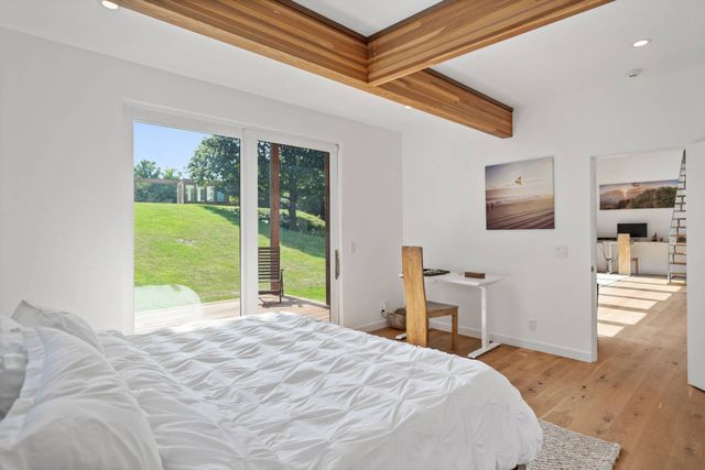 a bedroom with a bed and a large window