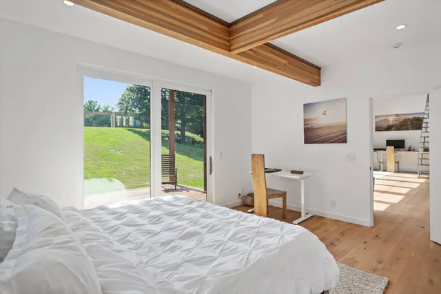 a bedroom with a bed and a large window