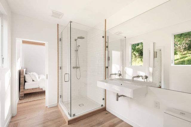 a bathroom with a tub sink and mirror