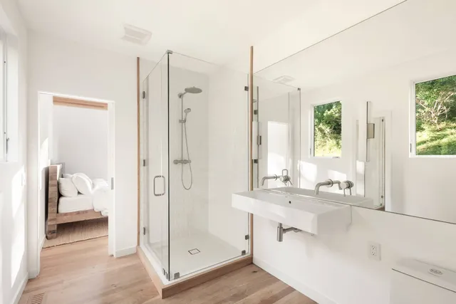 a bathroom with a tub sink and mirror