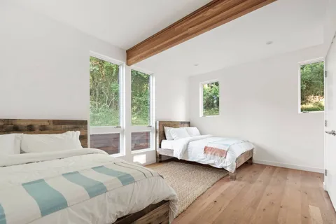 a bedroom with a bed and a large window