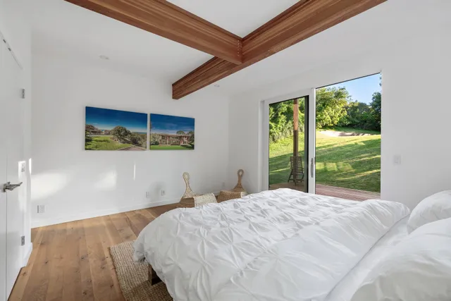 a bedroom with a bed and a large window