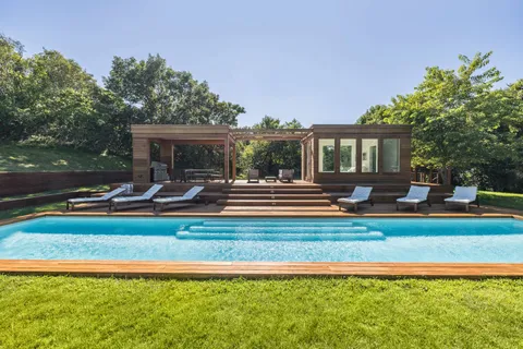 a view of a house with swimming pool and porch