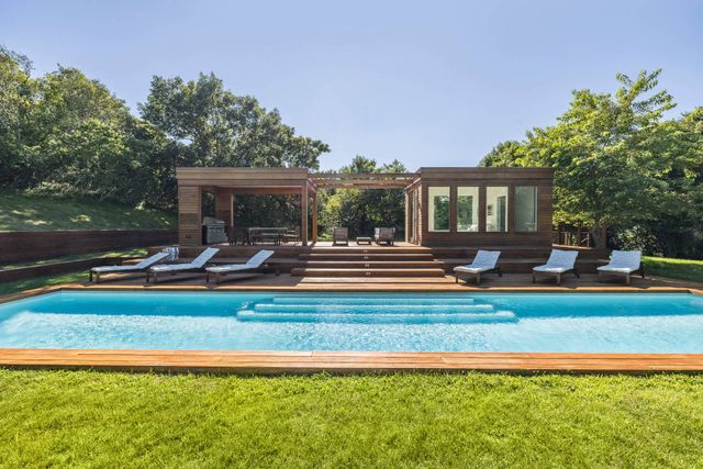 a view of a house with swimming pool and porch