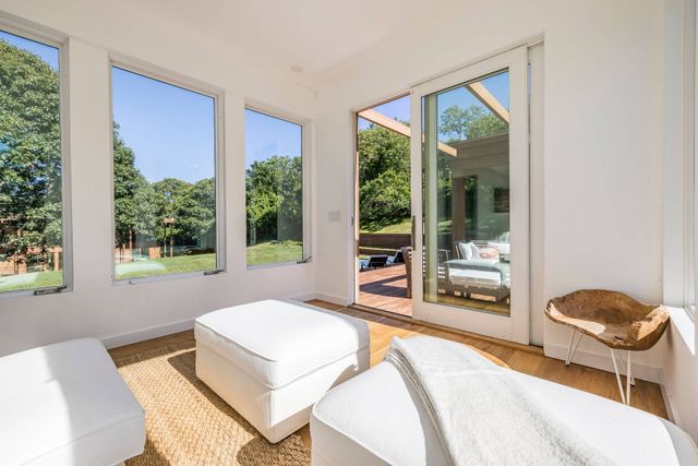 a living room with hardwood floor and a large window