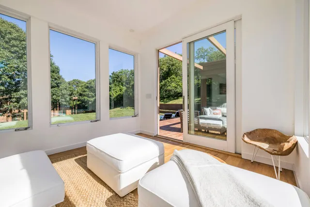 a living room with hardwood floor and a large window