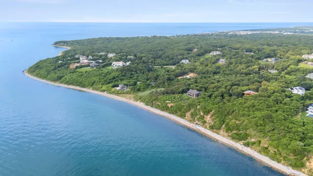 a view of a green field with an ocean view