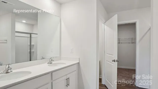 a bathroom with a sink double vanity and a mirror