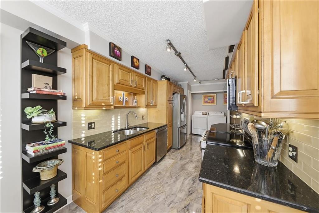3530 Piedmont Road Northeast, Unit F2 Atlanta, GA 30305 - Photo 13 of 50 a kitchen with stainless steel appliances granite countertop a sink a stove and cabinets