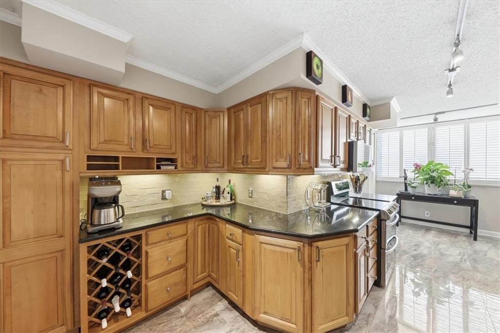3530 Piedmont Road Northeast, Unit F2 Atlanta, GA 30305 - Photo 16 of 50 a kitchen with stainless steel appliances granite countertop a sink stove and cabinets