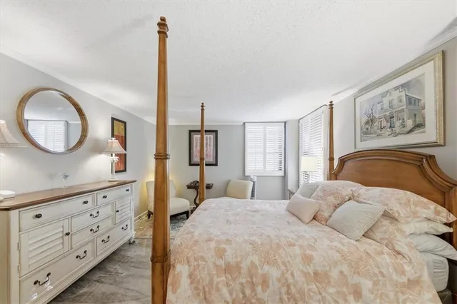 a bedroom with a bed and a dresser with mirror