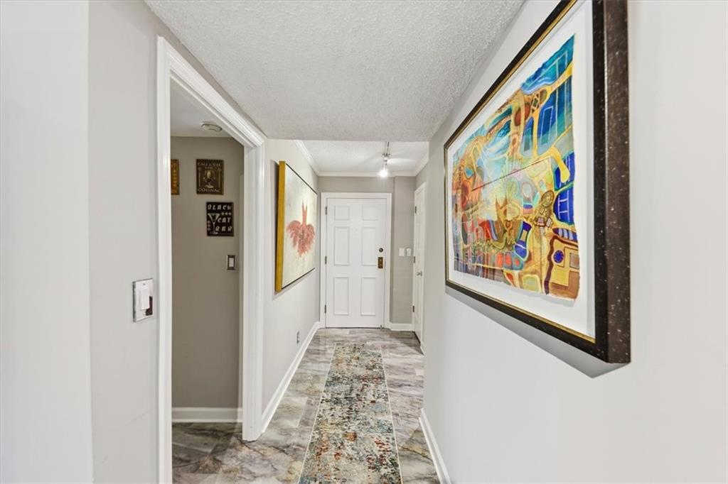 3530 Piedmont Road Northeast, Unit F2 Atlanta, GA 30305 - Photo 3 of 50 a view of a hallway with paintings on the wall