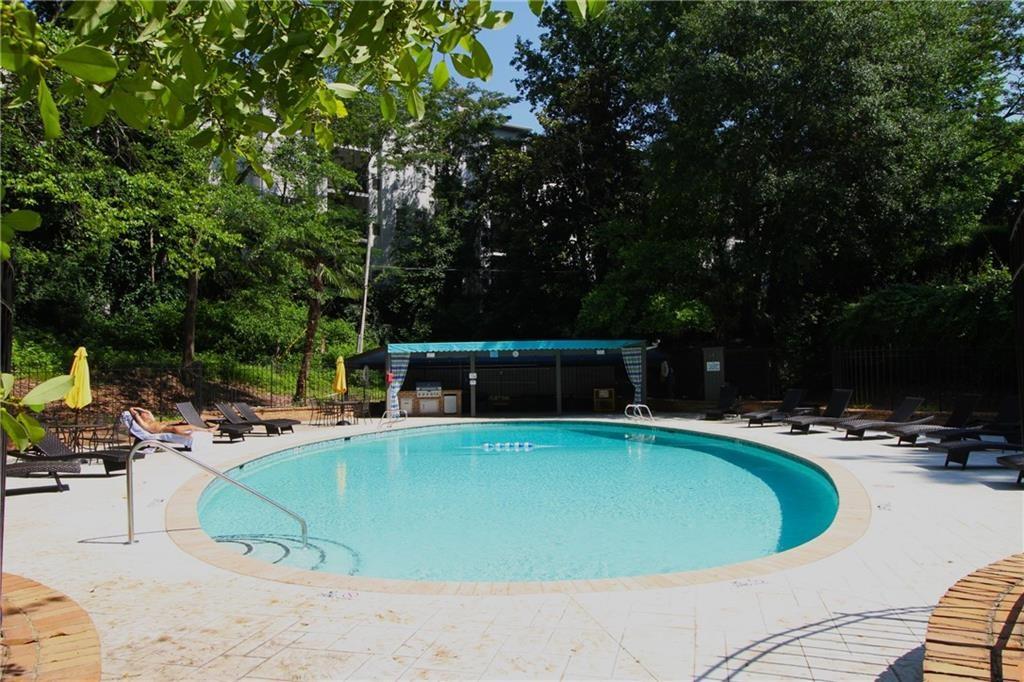 3530 Piedmont Road Northeast, Unit F2 Atlanta, GA 30305 - Photo 42 of 50 a view of a swimming pool with lounge chairs
