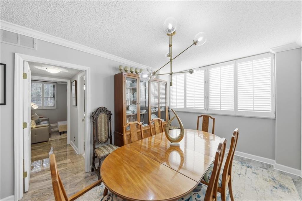 3530 Piedmont Road Northeast, Unit F2 Atlanta, GA 30305 - Photo 10 of 50 a view of a dining room with furniture window and wooden floor