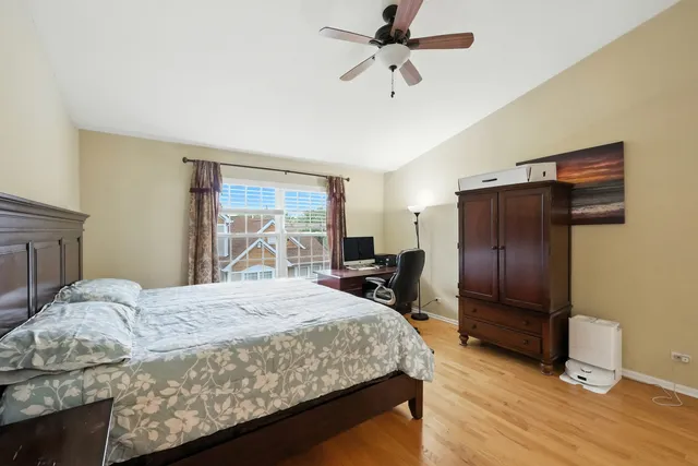 a bedroom with a bed dresser and a window