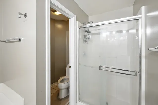 a bathroom that has a glass shower door