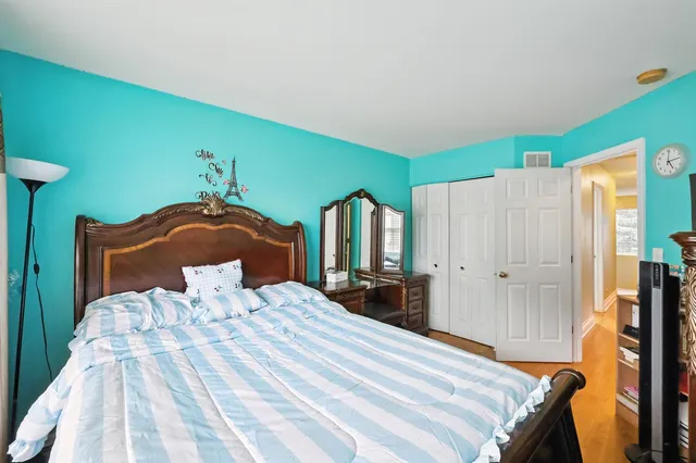 a bedroom with a bed and a closet