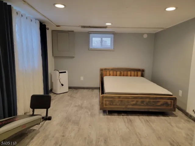 a spacious bedroom with a bed and a cabinets