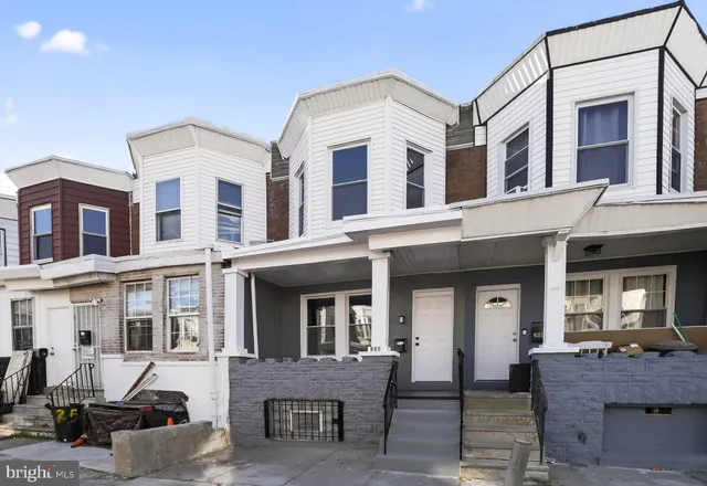 a view of a hallway and a livingroom with furniture