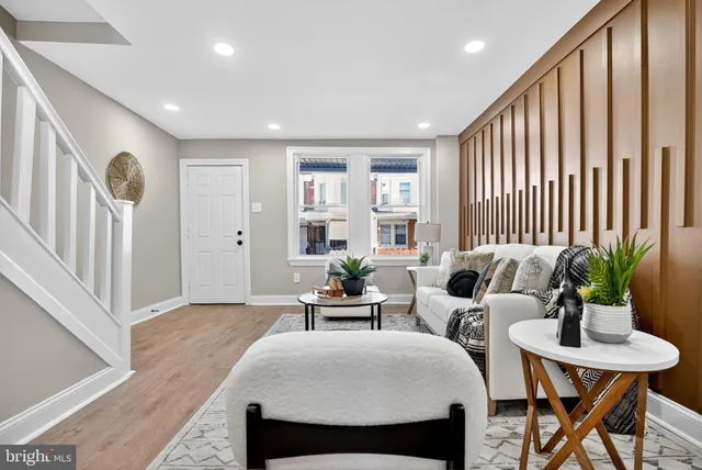 a living room with furniture and a potted plant