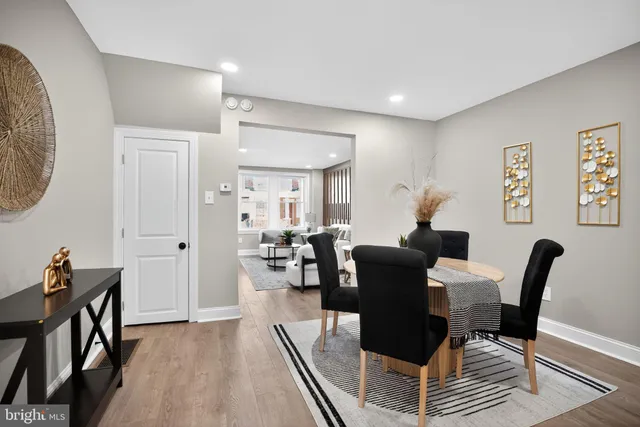 a dining room with furniture and wooden floor