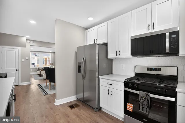 a kitchen with stainless steel appliances a stove microwave and refrigerator