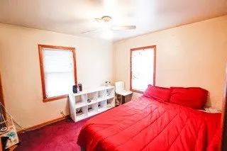 a bedroom with bed and a window