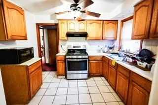 a kitchen with a stove a sink and a microwave