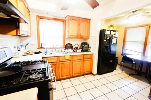a kitchen with stainless steel appliances a stove a sink and a refrigerator