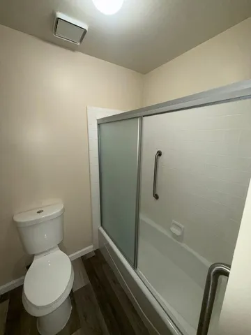 a bathroom with a toilet and a shower