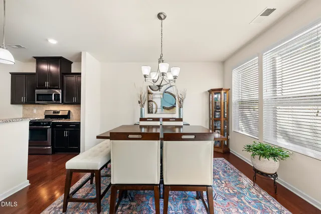 a kitchen with a table and chairs in it