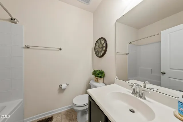 a bathroom with a toilet sink and vanity