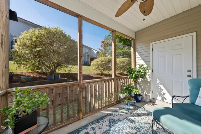a view of a balcony with chair and wooden floor