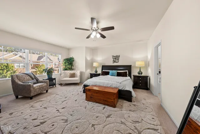 a bedroom with a bed couch and a window