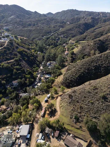 an aerial view of residential house and sandy dunes