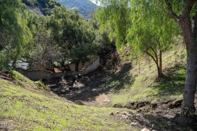 an aerial view of mountain with residential house and mountains in the background